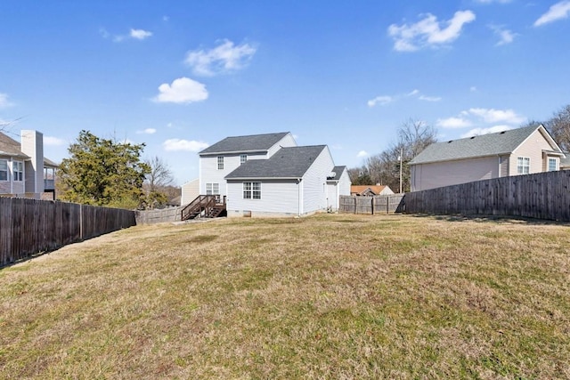 rear view of property featuring a yard