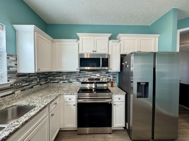 kitchen featuring white cabinetry and appliances with stainless steel finishes