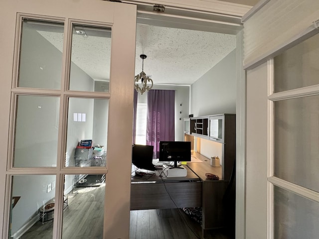 office area with hardwood / wood-style flooring, a chandelier, and a textured ceiling