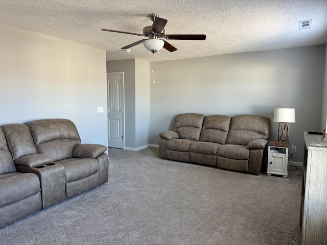 living room with a textured ceiling, ceiling fan, and carpet flooring