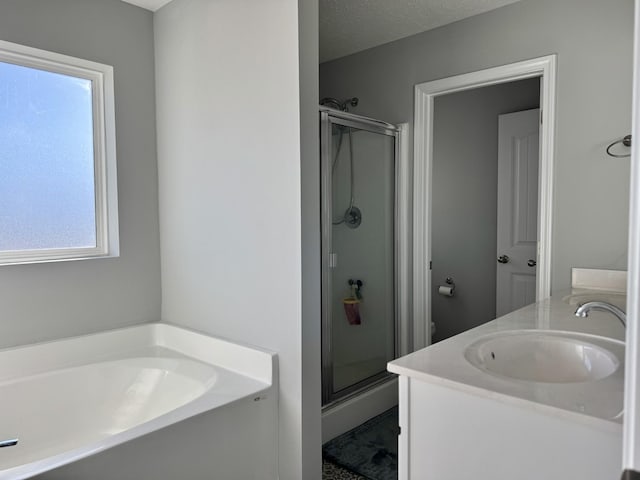 full bathroom featuring vanity, toilet, independent shower and bath, and a textured ceiling