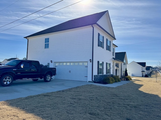 view of home's exterior with a garage and a lawn