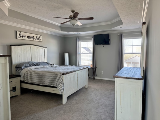 bedroom featuring light carpet, a tray ceiling, and a textured ceiling