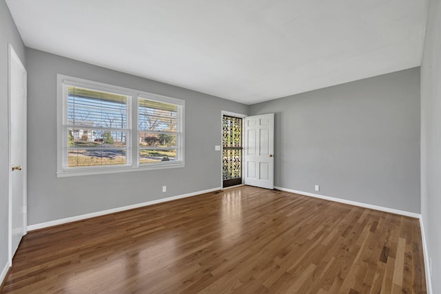 empty room featuring dark hardwood / wood-style flooring