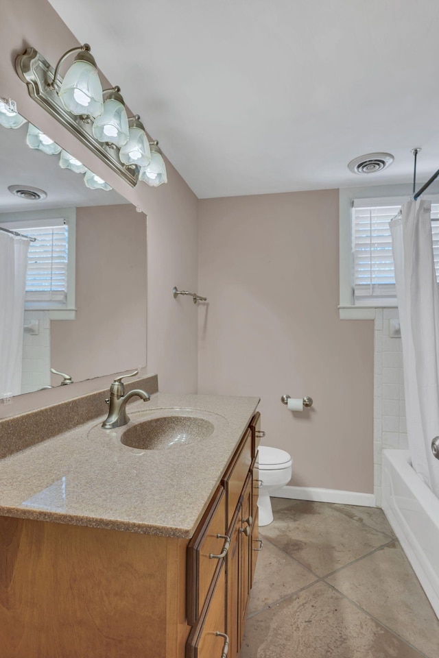 full bathroom featuring vanity, toilet, tile patterned flooring, and shower / tub combo