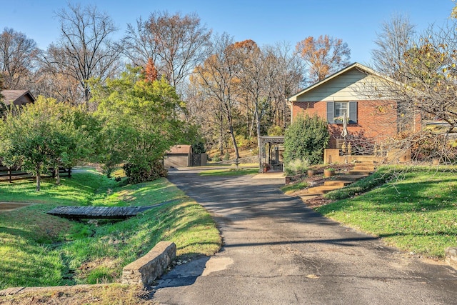 view of side of property featuring an outbuilding, a garage, and a yard