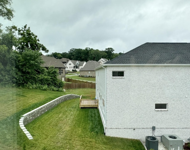 view of property exterior featuring a yard, cooling unit, and a deck