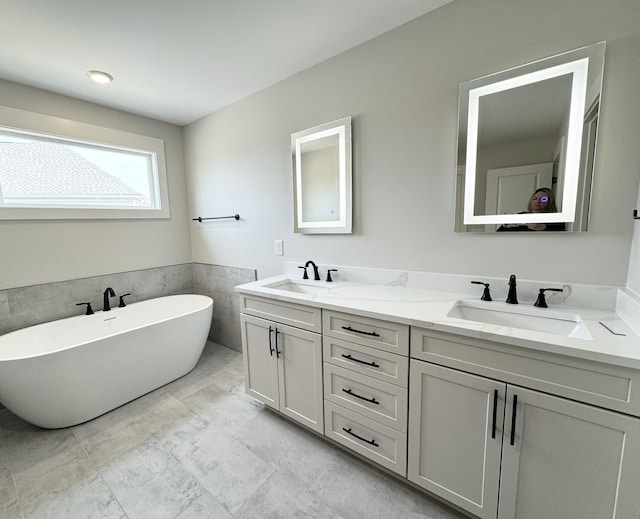 bathroom featuring vanity and a bath