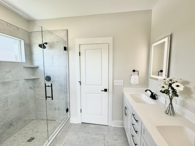 bathroom with vanity and a shower with door