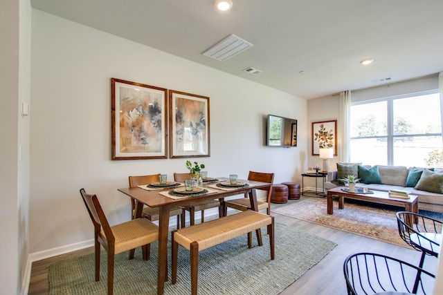 dining space with wood-type flooring