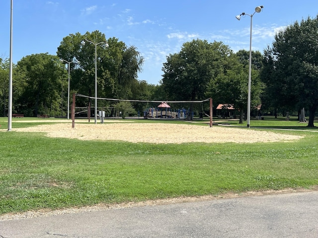 view of home's community featuring a lawn and volleyball court