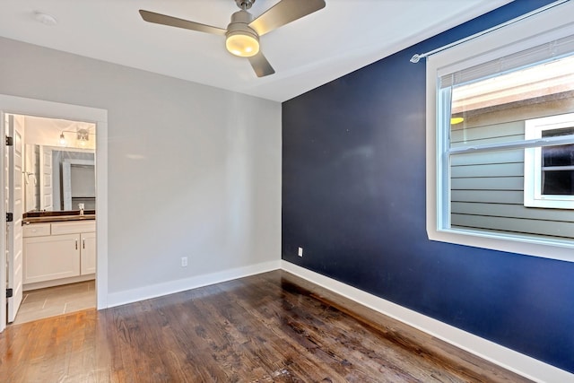 unfurnished room with dark hardwood / wood-style flooring and ceiling fan