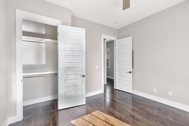 unfurnished bedroom featuring dark wood-type flooring, ceiling fan, and a closet