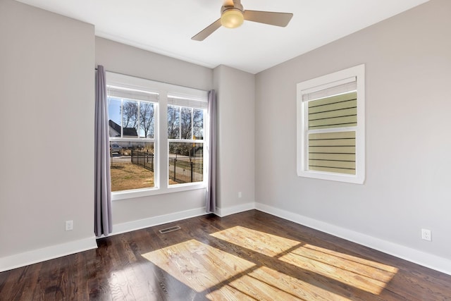 empty room featuring ceiling fan and dark hardwood / wood-style flooring