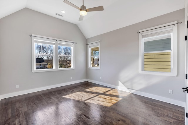 empty room featuring dark wood-type flooring, ceiling fan, and lofted ceiling