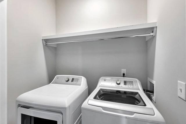 laundry area with independent washer and dryer