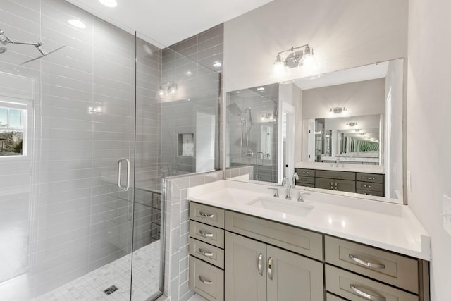 bathroom featuring an enclosed shower and vanity