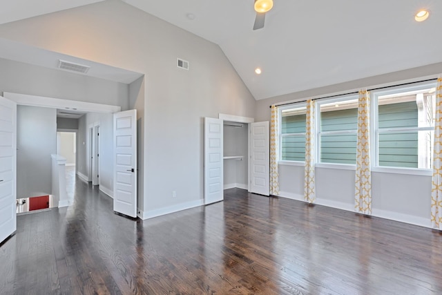 unfurnished bedroom featuring dark wood-type flooring, high vaulted ceiling, and ceiling fan