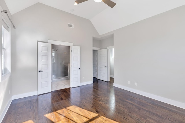 unfurnished bedroom featuring multiple windows, dark hardwood / wood-style floors, ceiling fan, and ensuite bathroom