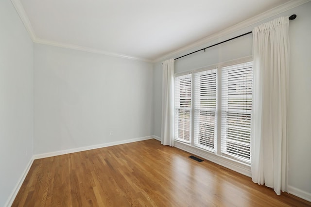 unfurnished room featuring crown molding and wood-type flooring