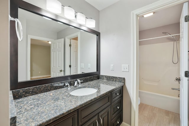 full bathroom with vanity, tub / shower combination, and toilet