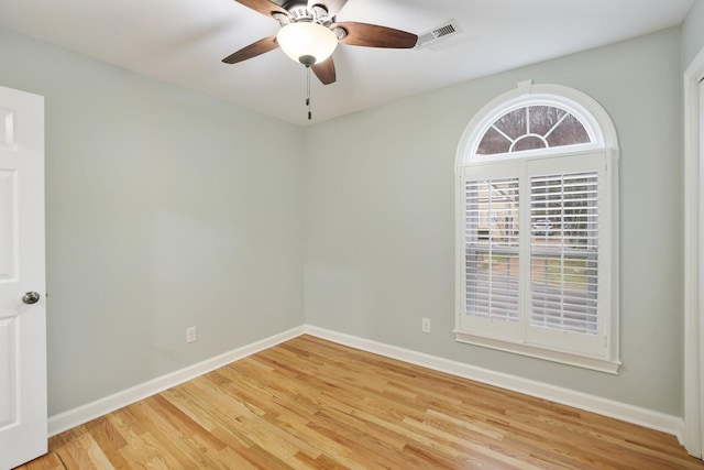 empty room featuring ceiling fan and hardwood / wood-style floors