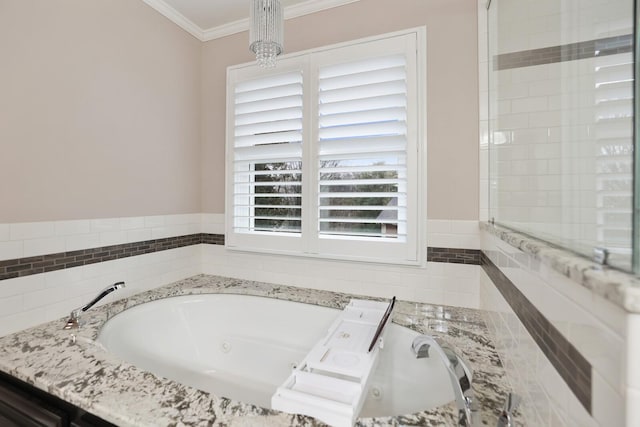 bathroom featuring crown molding and a tub