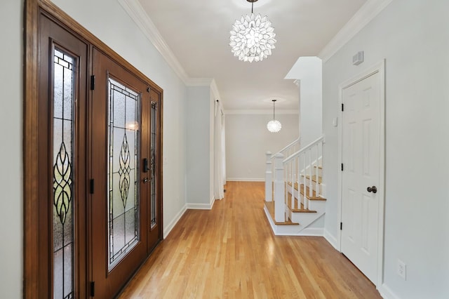 entrance foyer featuring crown molding, a notable chandelier, and light hardwood / wood-style floors