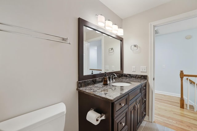 bathroom featuring hardwood / wood-style flooring, vanity, and toilet