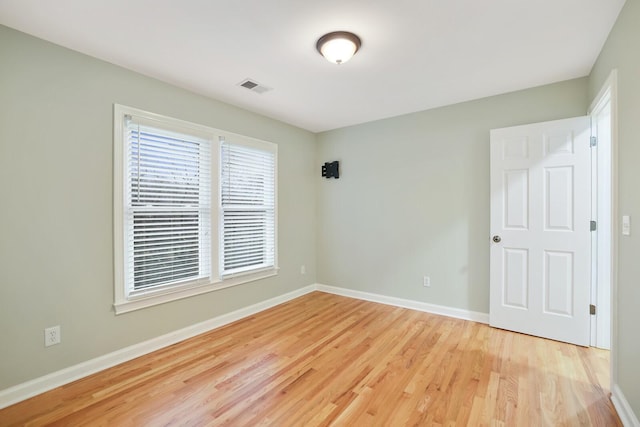 unfurnished room with light hardwood / wood-style flooring