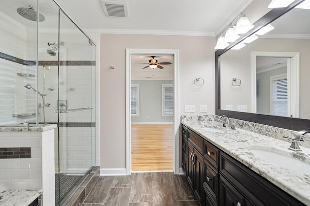 bathroom featuring crown molding, vanity, and a shower with door