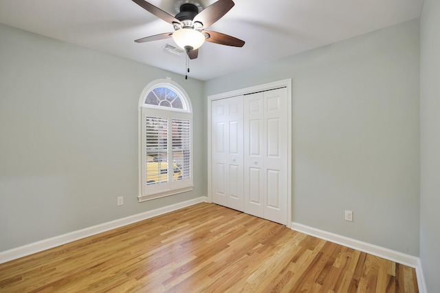 unfurnished bedroom with a closet, ceiling fan, and light hardwood / wood-style flooring