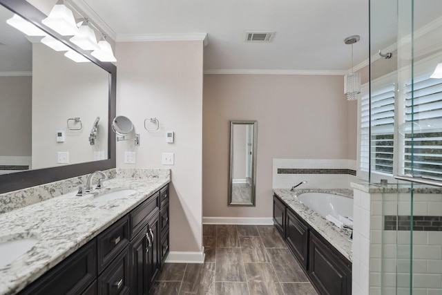 bathroom featuring ornamental molding, a tub, and vanity