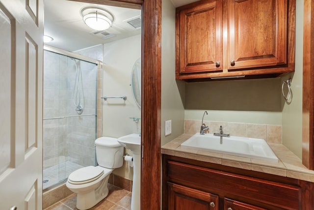 bathroom with tile patterned flooring, sink, a shower with door, and toilet