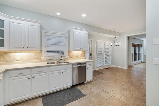 kitchen with sink, decorative light fixtures, dishwasher, white cabinets, and backsplash