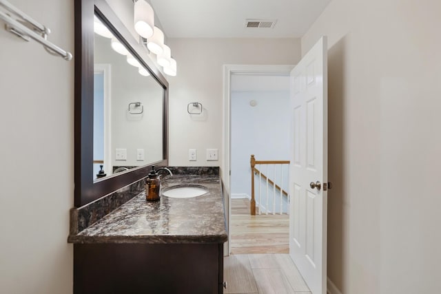 bathroom with hardwood / wood-style flooring and vanity