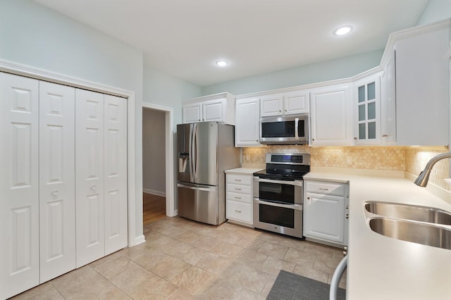 kitchen featuring white cabinetry, sink, tasteful backsplash, and appliances with stainless steel finishes