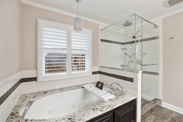 bathroom with ornamental molding and separate shower and tub