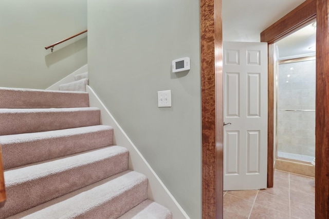 stairway with tile patterned floors