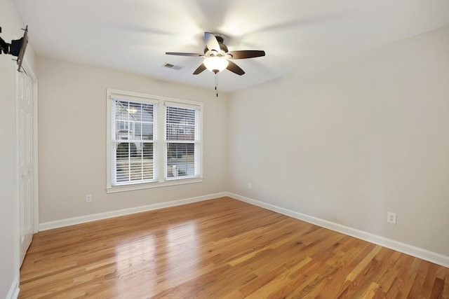 empty room featuring ceiling fan and light wood-type flooring