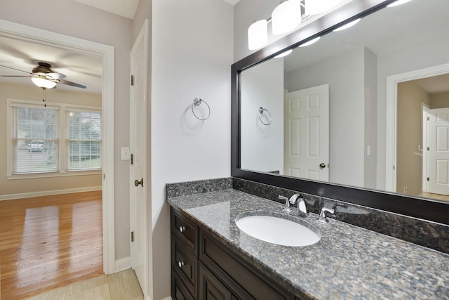 bathroom with ceiling fan, vanity, and hardwood / wood-style floors