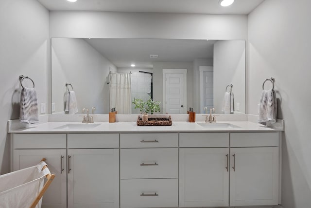 full bath with recessed lighting, a sink, a shower with shower curtain, and double vanity