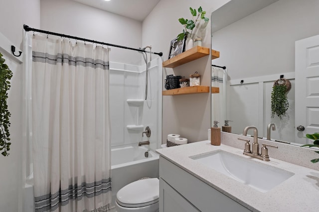 full bathroom featuring vanity, shower / bath combo with shower curtain, and toilet