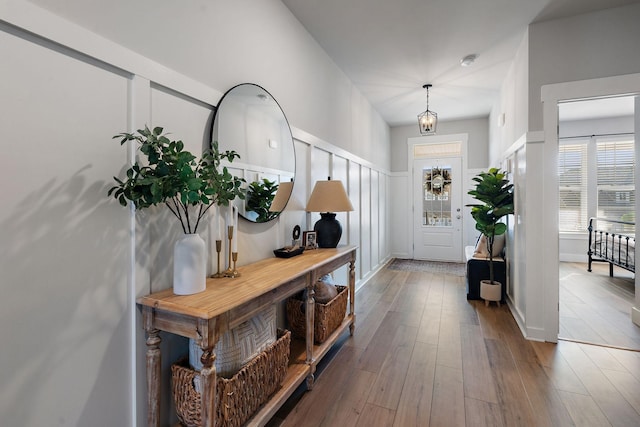 foyer featuring baseboards and wood finished floors