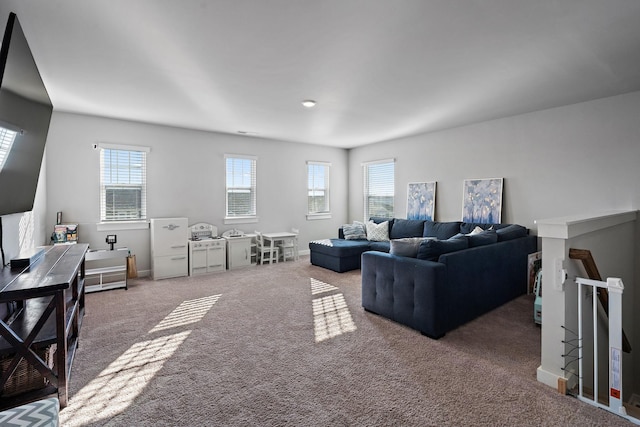 living room featuring carpet flooring and baseboards