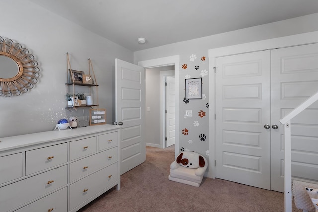 bedroom with light carpet and a closet