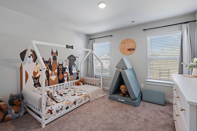 carpeted bedroom featuring visible vents and baseboards