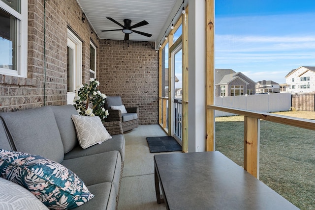 unfurnished sunroom with ceiling fan