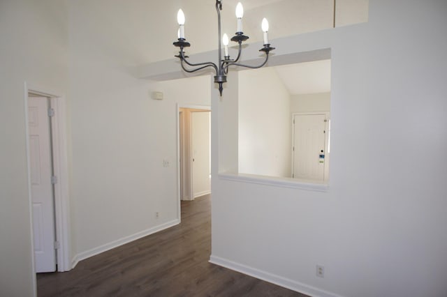 unfurnished dining area with a notable chandelier and dark hardwood / wood-style flooring