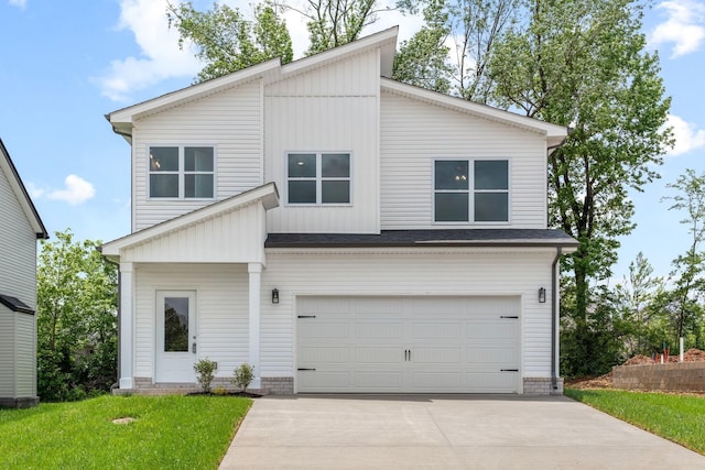 view of front of home featuring a garage and a front yard